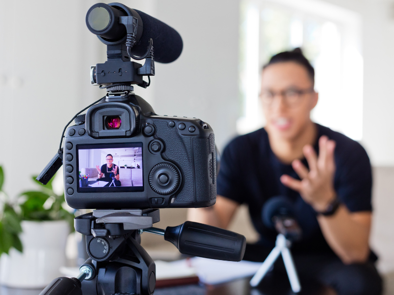 Man recording an explainer video using a camera and microphone